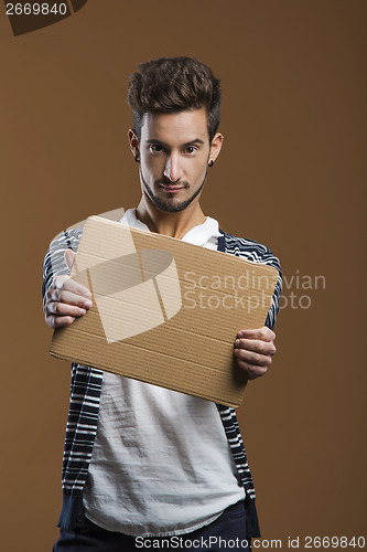 Image of Young man holding a card board