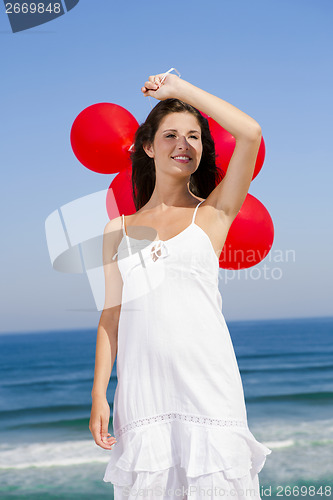 Image of Beautiful girl holding red ballons