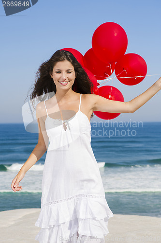 Image of Beautiful girl holding red ballons