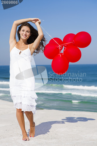 Image of Beautiful girl holding red ballons