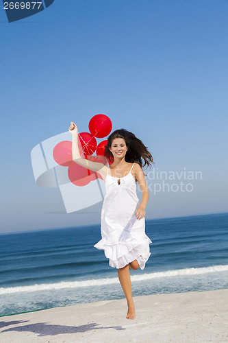 Image of Beautiful girl running with red ballons