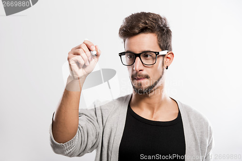 Image of Young man writing on a glass