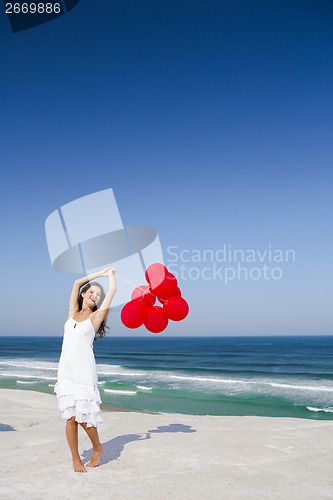 Image of Beautiful girl holding red ballons