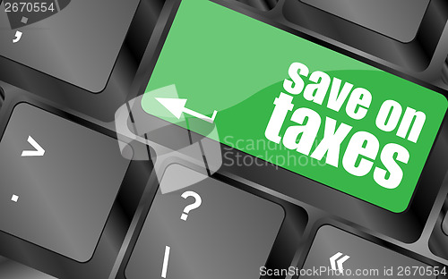 Image of save on taxes word on laptop keyboard key, business concept