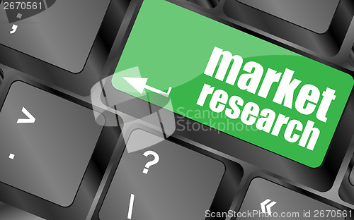 Image of key with market research text on laptop keyboard, business concept