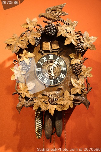 Image of old wall clock on orange background