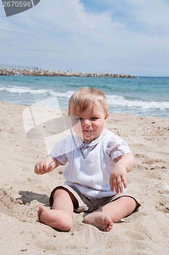 Image of Happy boy sitting on the beach