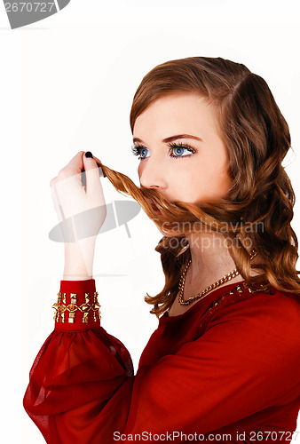 Image of Girl with hair on mouth.