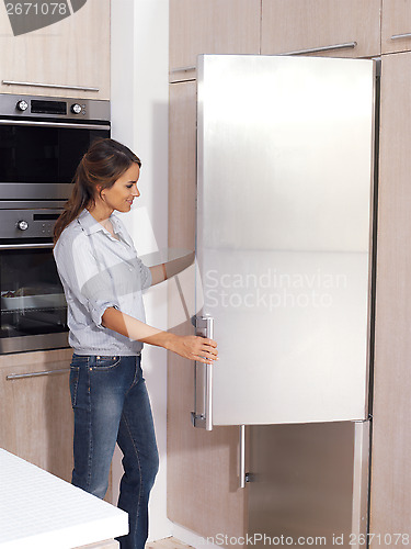 Image of woman looking in the fridge vy