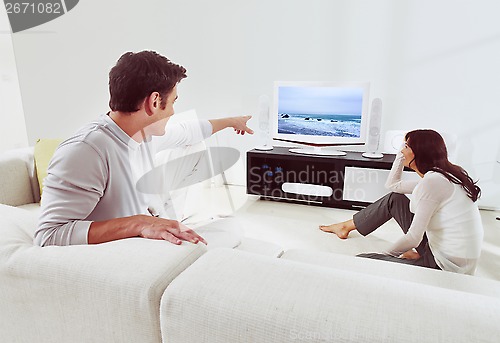 Image of couple on sofa and watching tv