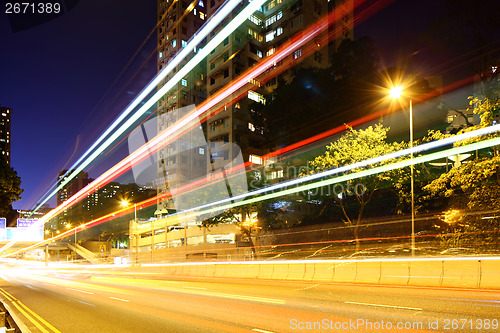 Image of Busy traffic trail in city at night