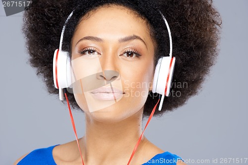 Image of Trendy African American woman listening to music