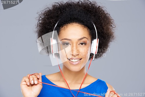 Image of Trendy African American woman listening to music