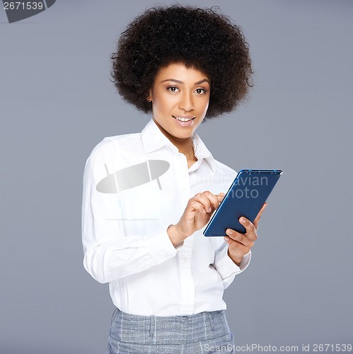 Image of Attractive Afro-American woman with a tablet