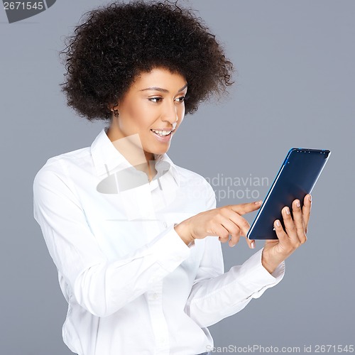 Image of Attractive Afro-American woman with a tablet