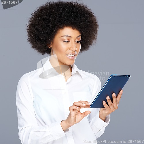 Image of Beautiful African American woman using her tablet