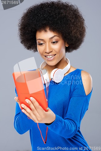 Image of Beautiful young woman selecting a tune