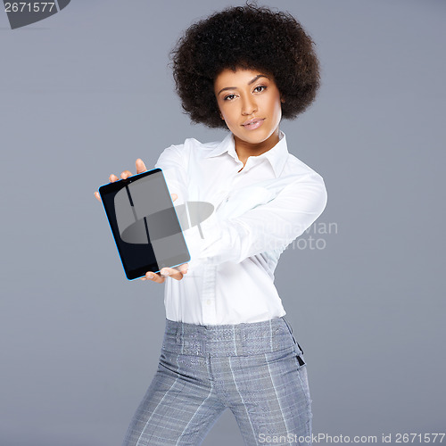 Image of Stylish African American woman showing a tablet