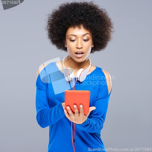 Image of Beautiful young woman selecting a tune