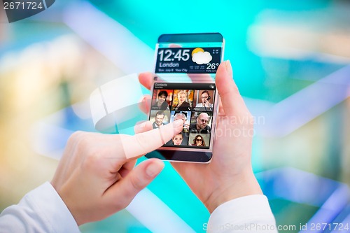 Image of Smartphone with transparent screen in human hands.