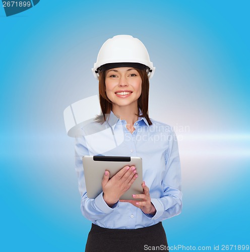 Image of young smiling businesswoman in white helmet