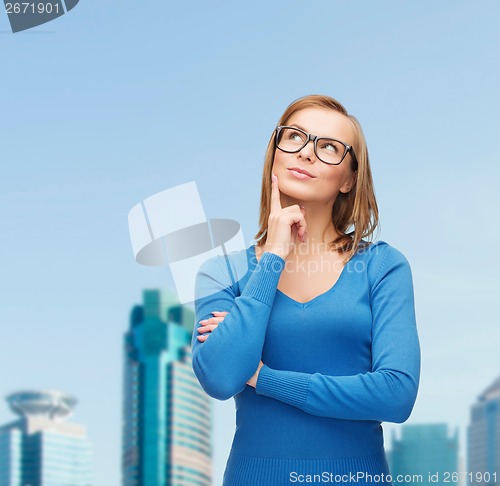 Image of happy woman in black eyeglasses dreaming