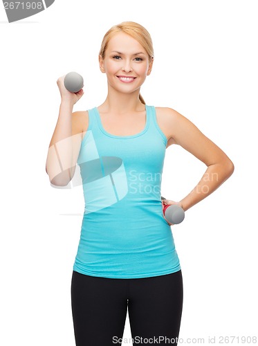 Image of young sporty woman with light dumbbells