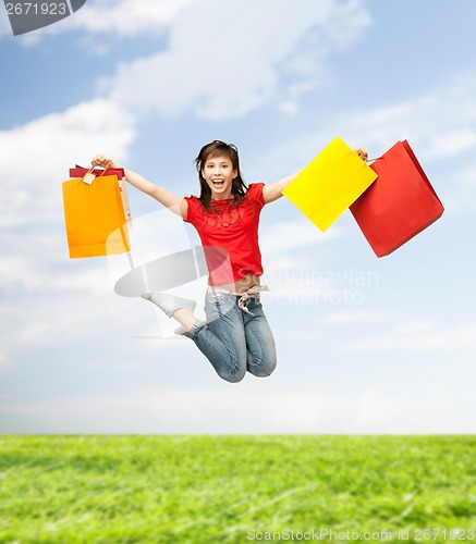 Image of excited girl with shopping bags