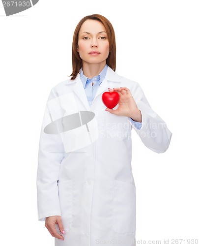 Image of serious female doctor with heart