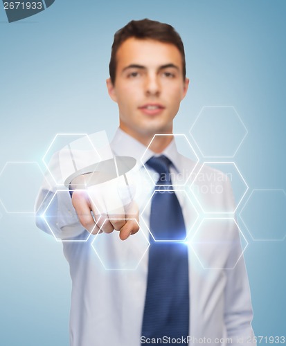 Image of buisnessman pointing finger to virtual screen