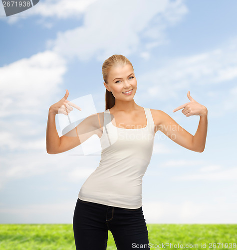 Image of woman in blank white t-shirt pointing at herself