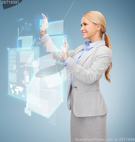 Image of smiling businesswoman working with virtual screen