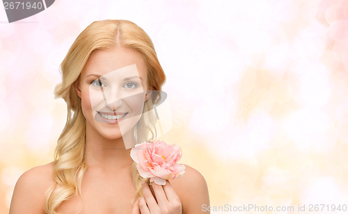 Image of smiling woman with peony flower