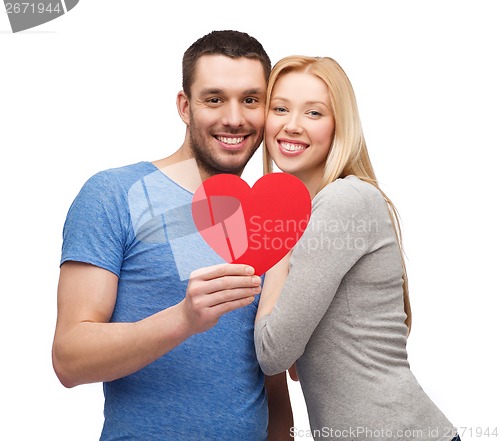 Image of smiling couple holding big red heart