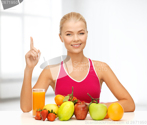 Image of woman with juice and fruits holding finger up