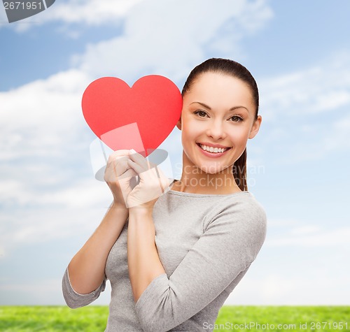 Image of smiling asian woman with red heart