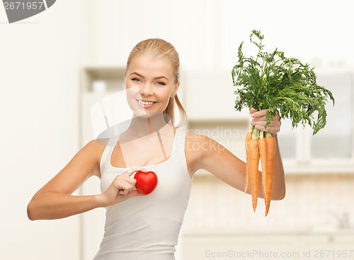 Image of woman holding heart symbol and carrots