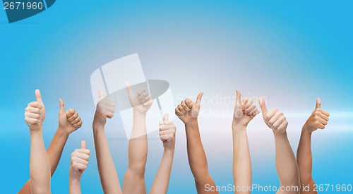 Image of human hands showing thumbs up