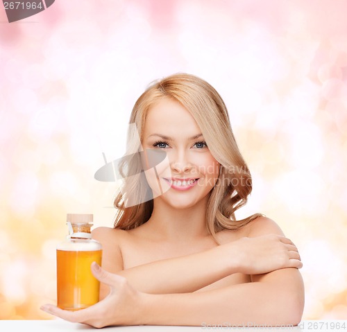 Image of happy woman with oil bottle