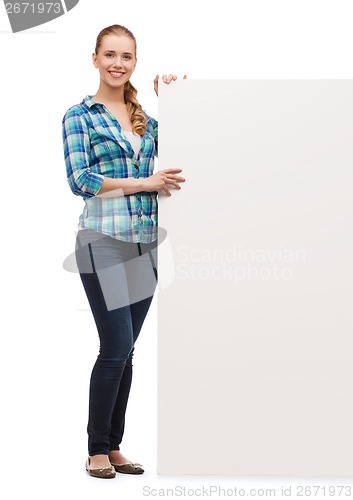 Image of smiling young woman with white blank board