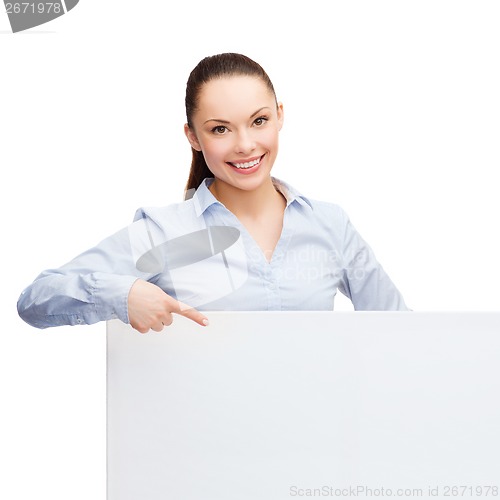 Image of businesswoman pointing finger to white blank board