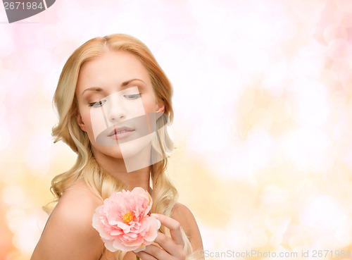 Image of lovely woman with peony flower