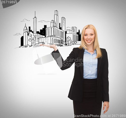 Image of smiling woman showing city sketch on her hand