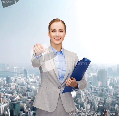 Image of smiling businesswoman with folder and keys