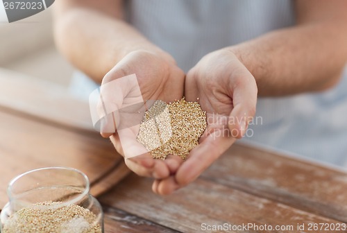 Image of cloes up of male cupped hands with quinoa