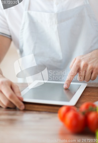 Image of closeup of man pointing finger to tablet pc