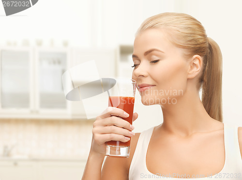 Image of young woman drinking tomato juice