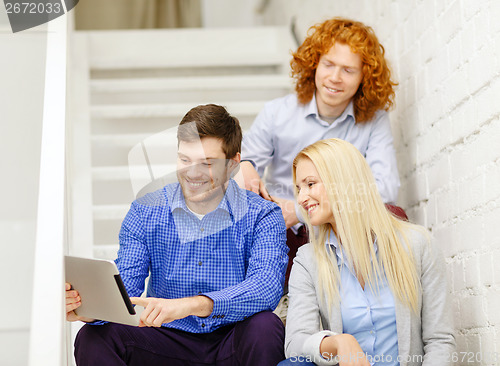 Image of team with tablet pc computer sitting on staircase