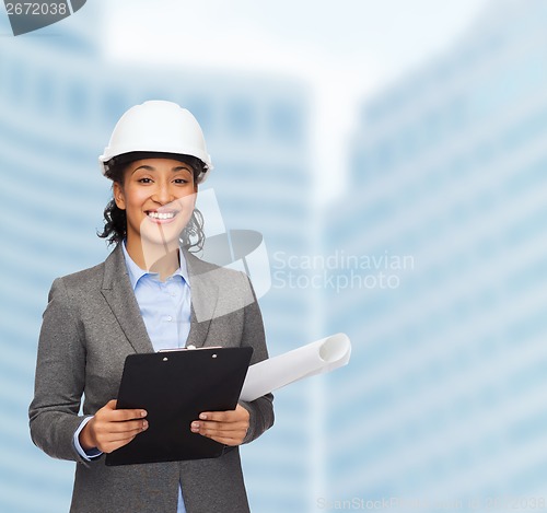 Image of businesswoman in white helmet with clipboard