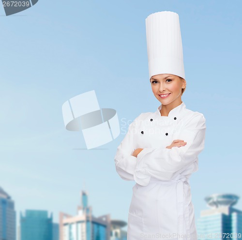 Image of smiling female chef with crossed arms